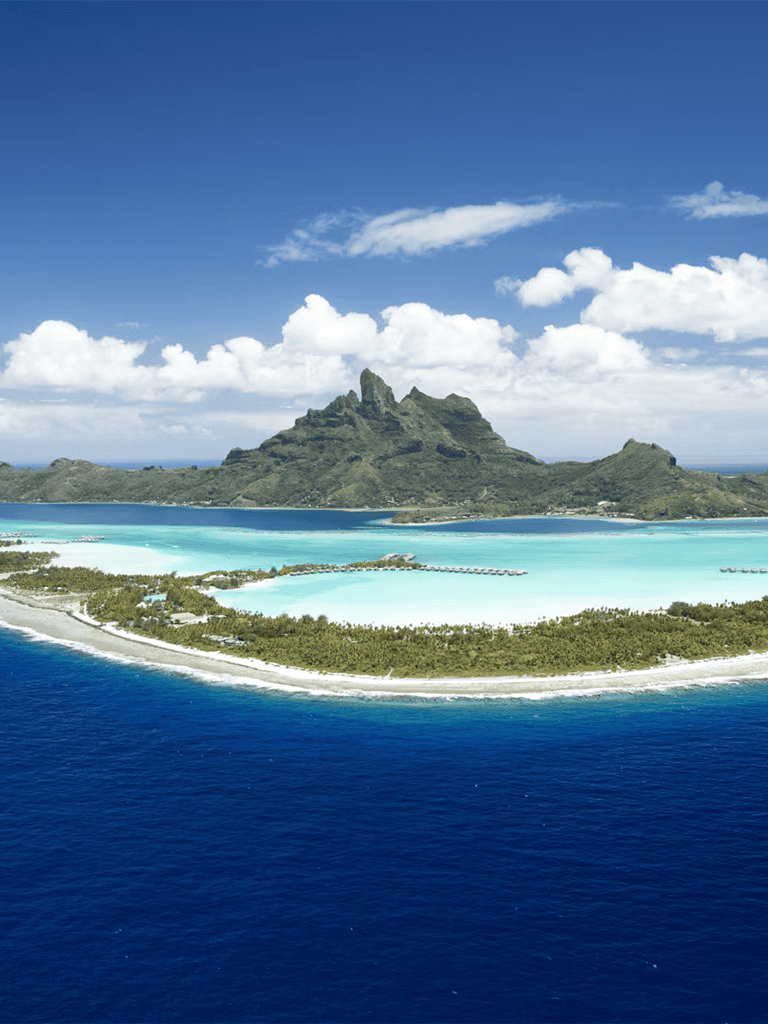 Serene tropical island with clear turquoise waters and lush greenery in a scenic ocean setting.