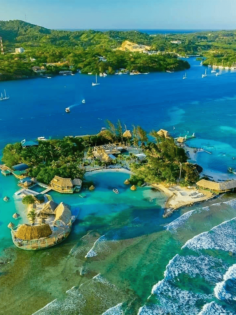 Relaxing tropical coastal resort with overwater bungalows and clear blue waters.