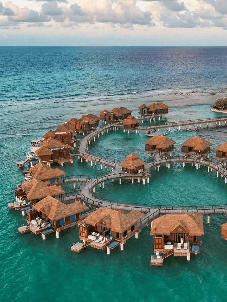 Overwater bungalows in the Caribbean with overwater walkways and stunning ocean views.