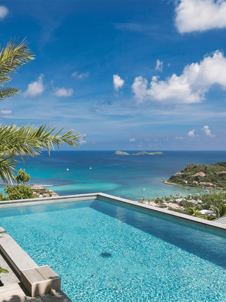 Stunning ocean view from infinity pool at tropical resort in Caribbean.