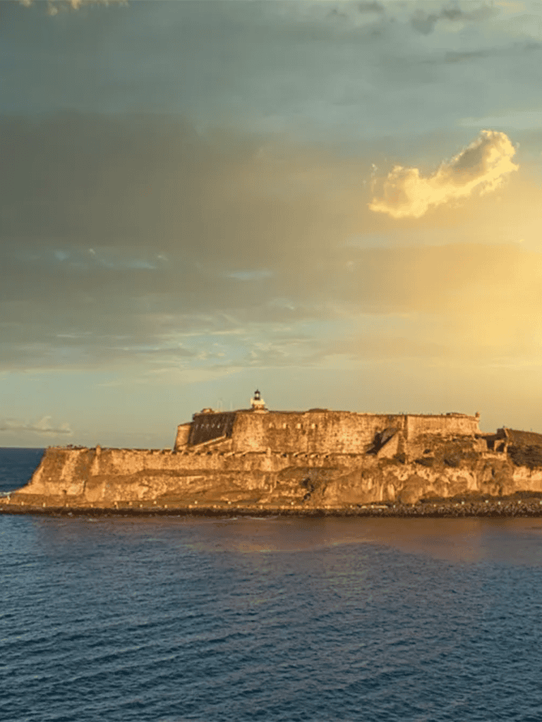 Historical fortress on a tropical island at sunset.