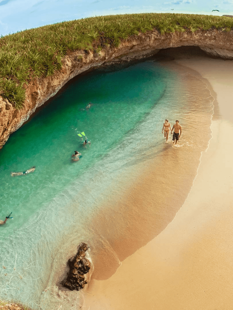 Secluded beach cove with turquoise waters and golden sand, ideal for swimming and relaxation.