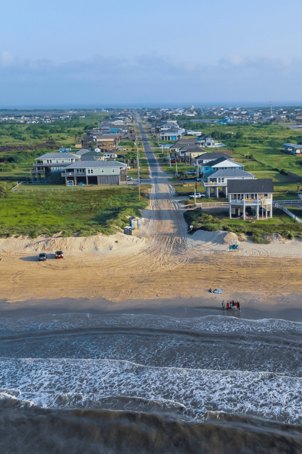 Colorful beach houses along the shoreline, offering scenic ocean views and vacation rentals.