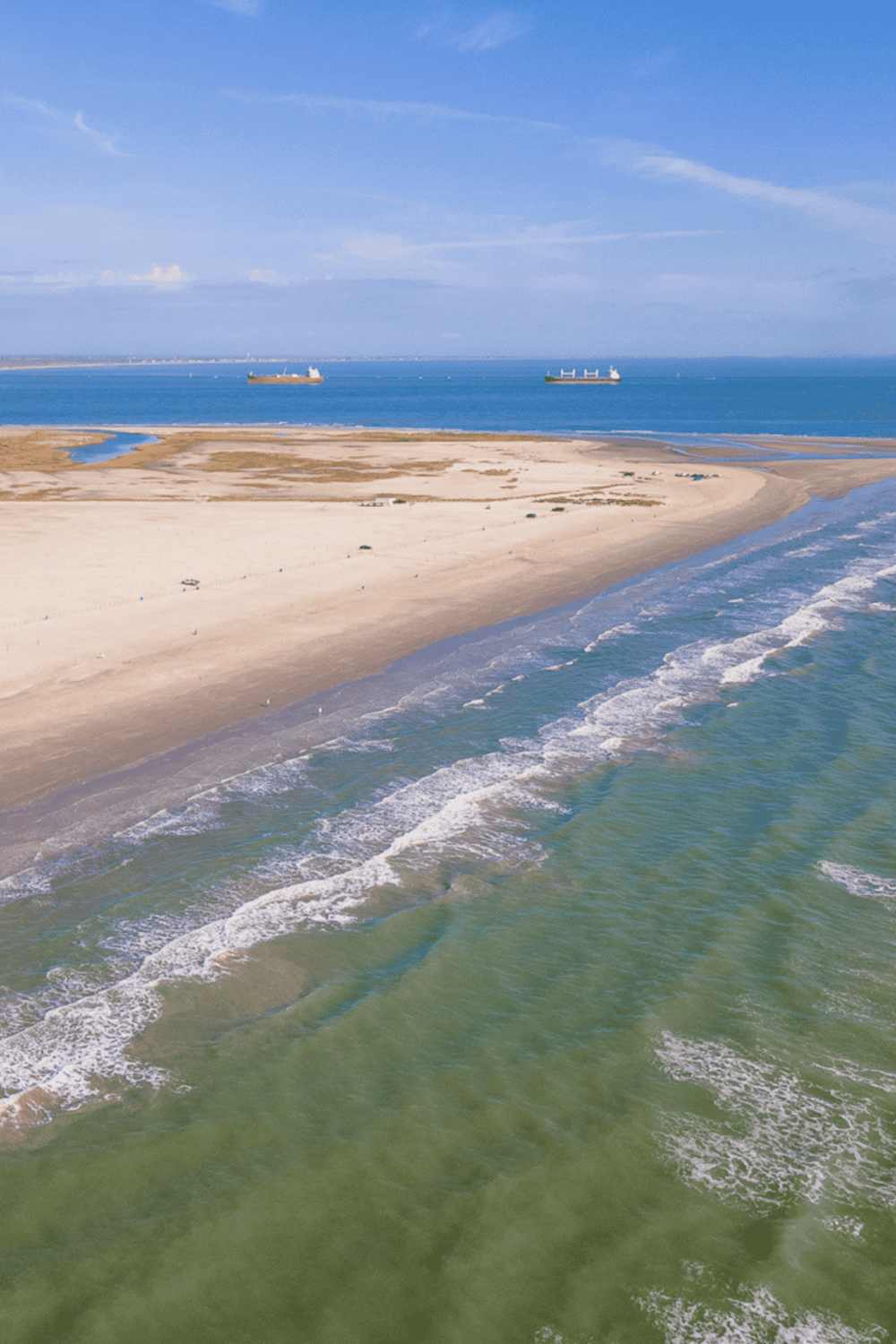 Seaside aerial view with ships, sandy beach, and ocean waves - perfect for travel and coastal adventures.