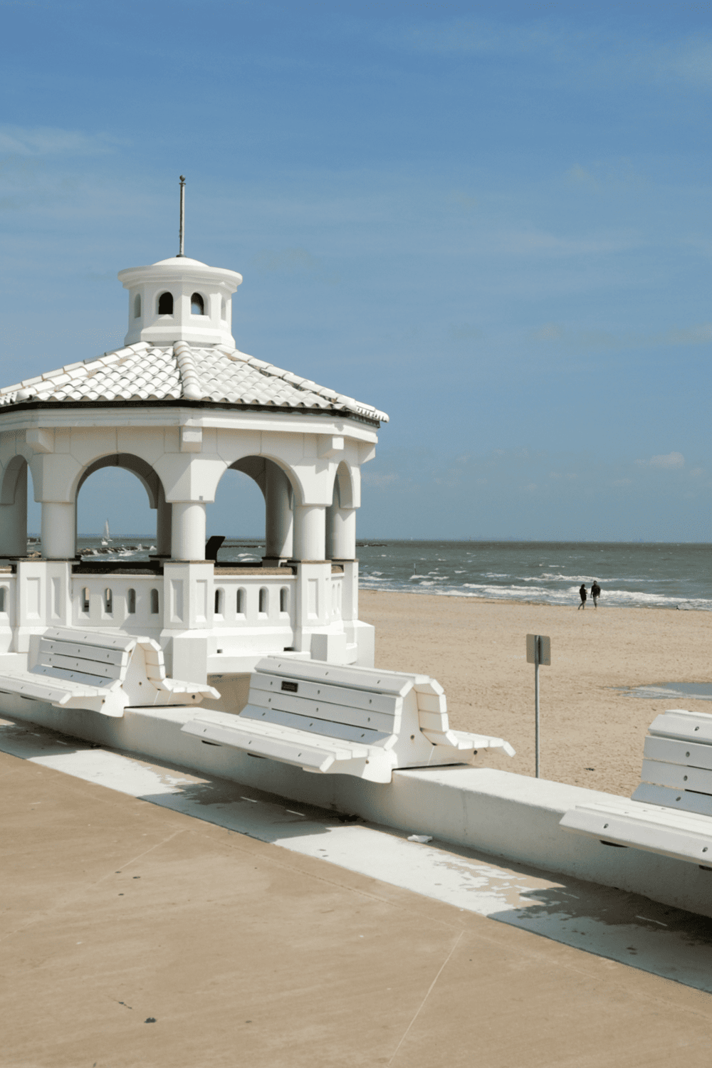 Seaside pavilion on sandy beach, ocean view, relaxing coastal scenery, vacation destination, QuestForDirections.