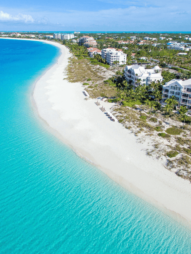 Luxurious beachfront properties along turquoise ocean in quest for directions.