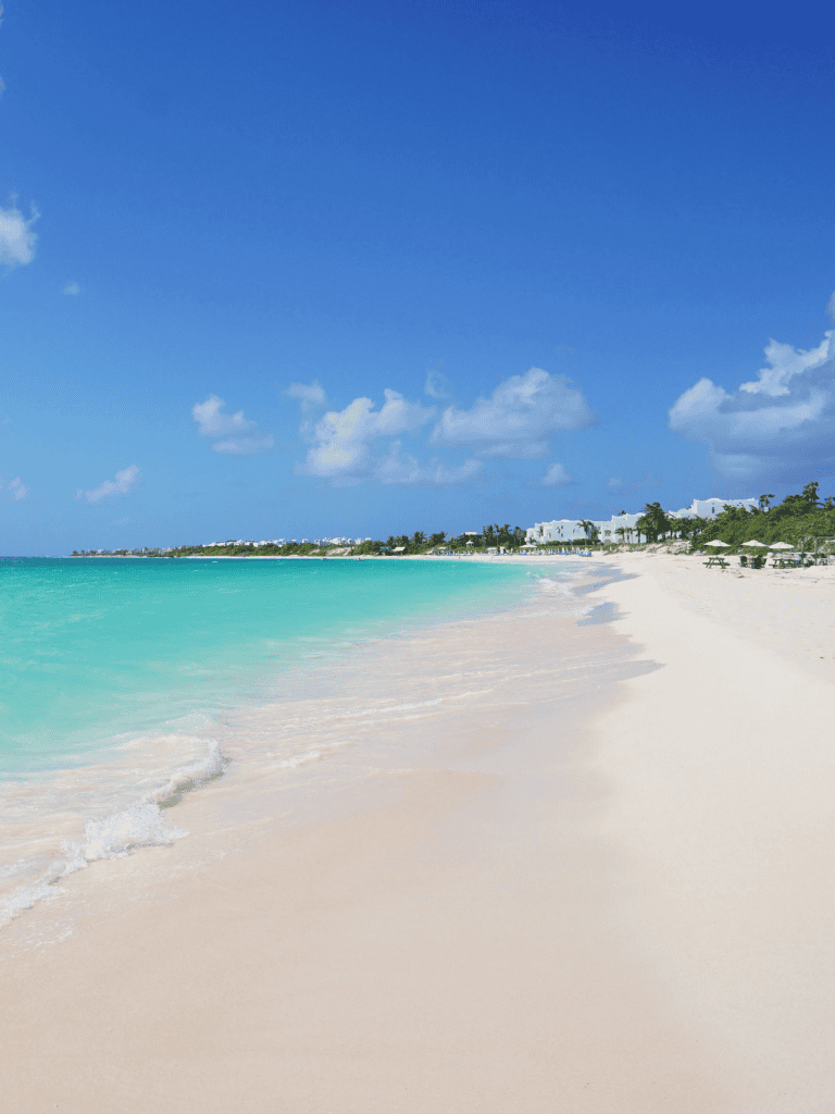 Tranquil Caribbean beach with white sand and turquoise waters, perfect for relaxation.