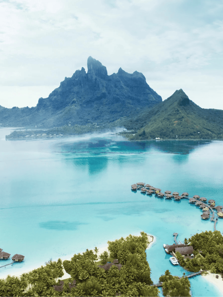 Vibrant tropical island with overwater bungalows and lush greenery, perfect for luxury travel and tropical vacations.