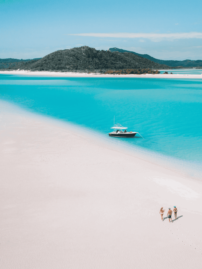Secluded tropical beach with clear turquoise waters and white sand, perfect for relaxing and exploring nature.
