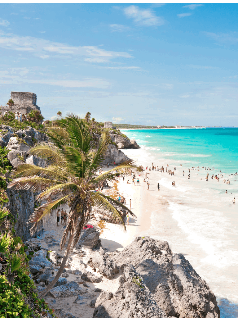 Vibrant Caribbean beach with turquoise waters, palm trees, and ancient ruins, perfect for travel destinations and vacation planning.