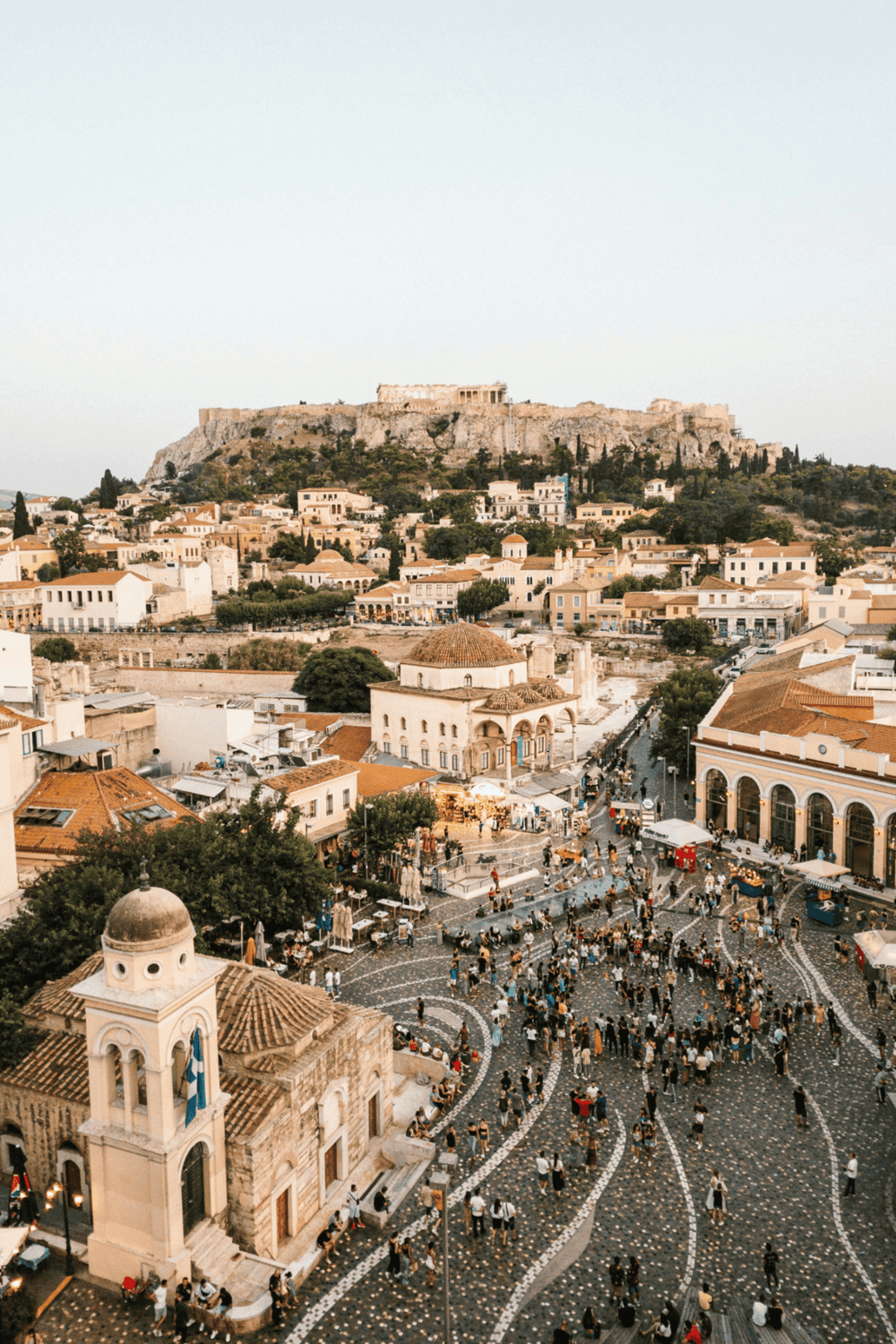 Ancient Athens city square with Parthenon in the background, vibrant urban scene, popular travel destination, historic Greek architecture.