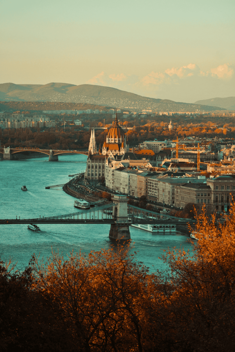 Historic Budapest cityscape with Chain Bridge and Parliament building on the Danube at sunset.