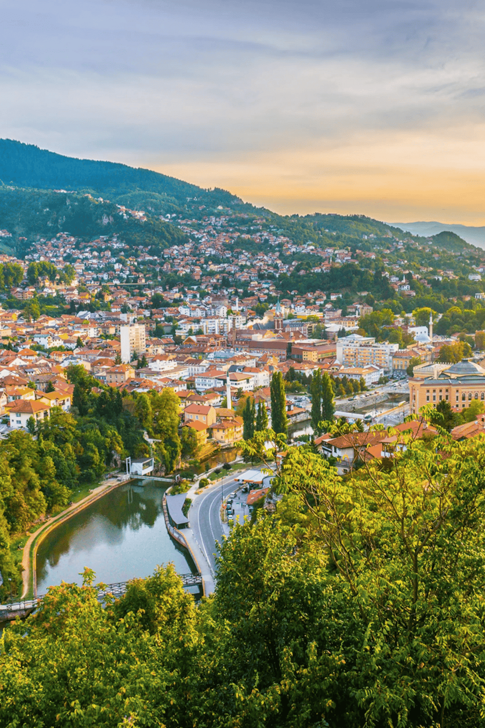 Colorful hillside cityscape with river and lush greenery, highlighting travel and navigation in scenic locations.