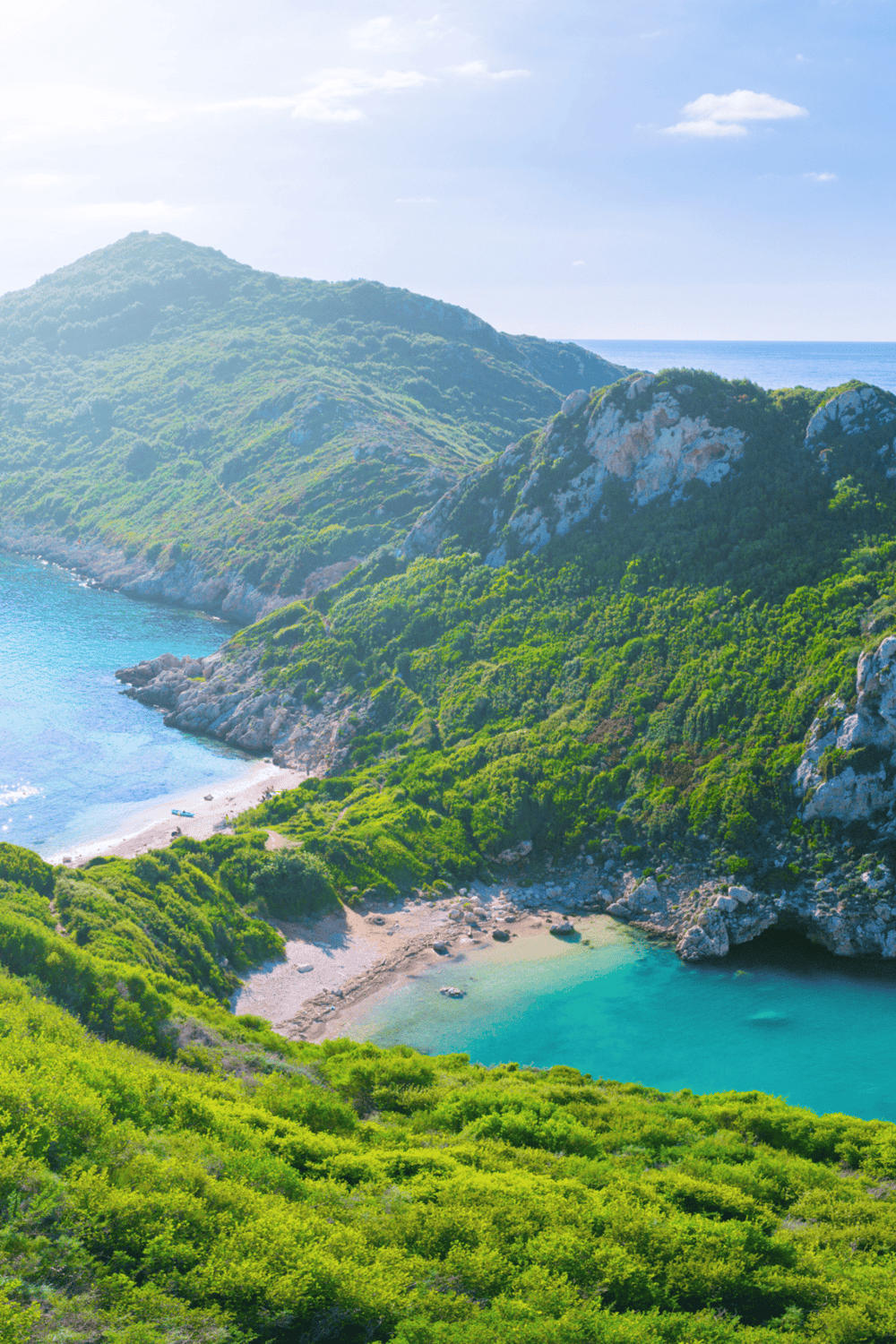 Secluded beach cove with lush green cliffs and turquoise waters, perfect for nature and coastal exploration.