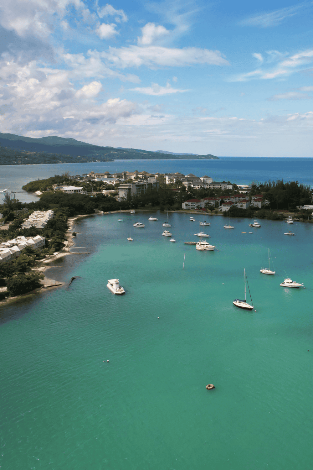 1. Coastal marina with sailboats and scenic mountain view.