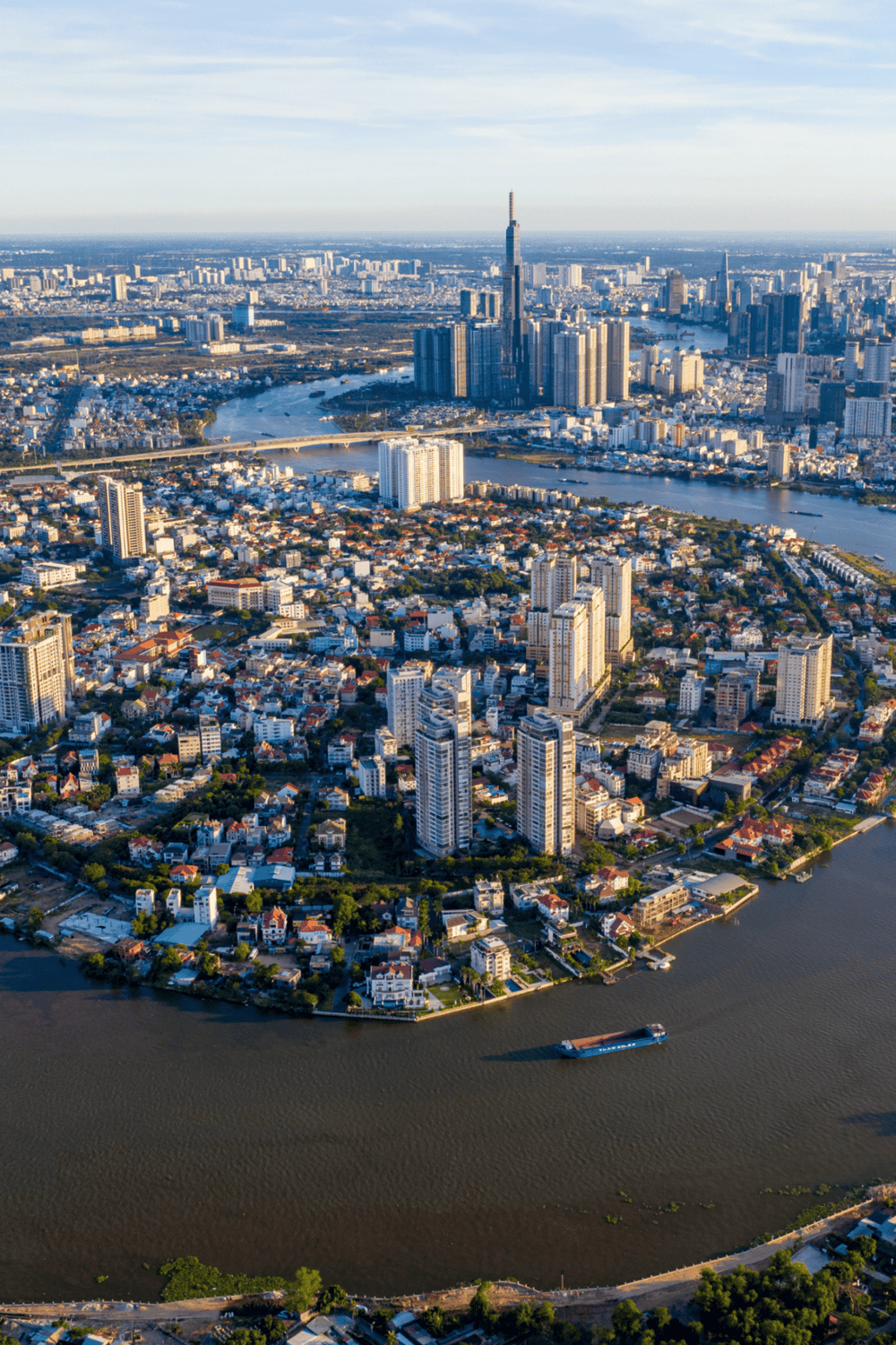 Aerial view of Tokyo skyline with skyscrapers, river, and cityscape at sunset.