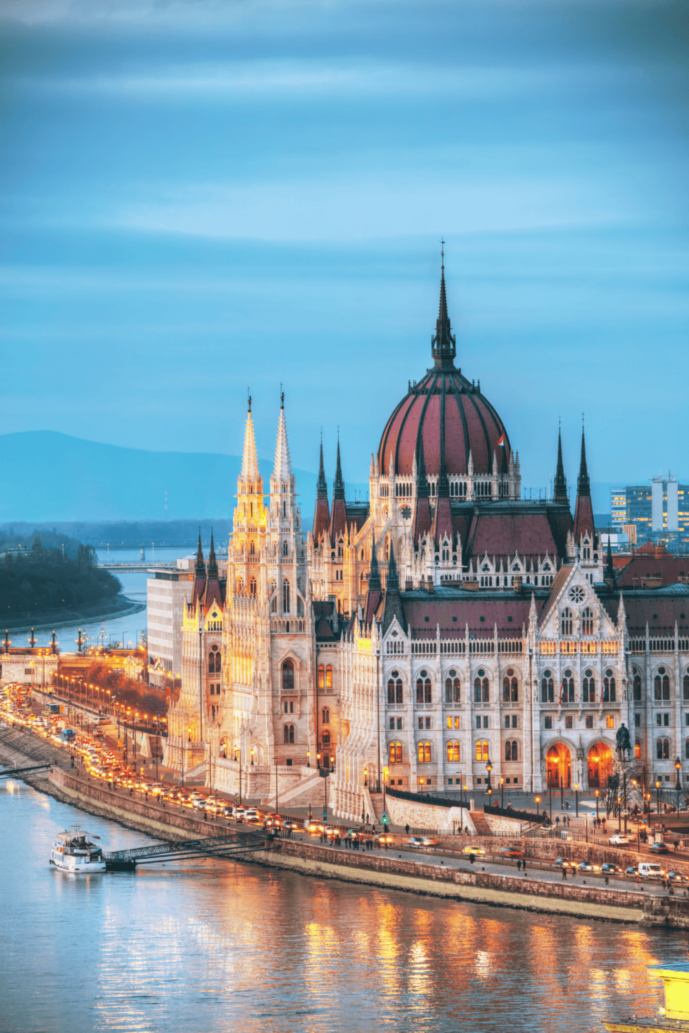 Majestic Hungarian Parliament Building illuminated at dusk in Budapest, showcasing stunning architecture.