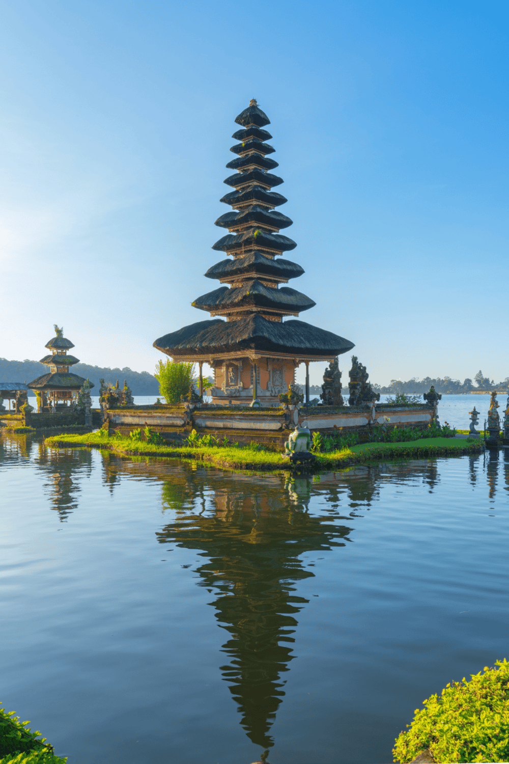 Ancient Balinese temple on a water lake, showcasing traditional architecture and scenic beauty.