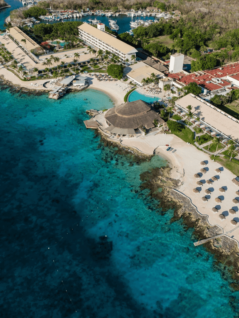 Elegant beachfront resort with pools and seaside relaxation on turquoise waters.