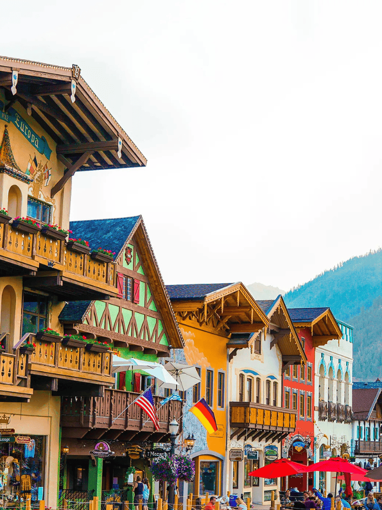 Colorful European-style houses in a popular tourist destination with vibrant architecture and mountain views.