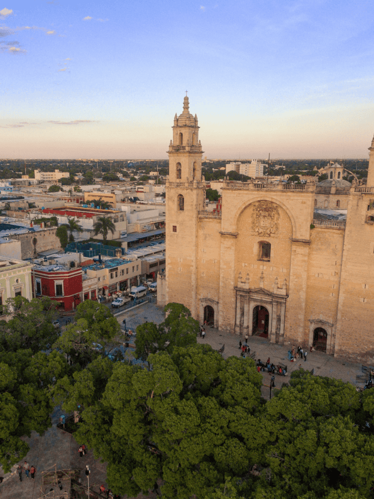 Ancient church in downtown with historic architecture and lush greenery, popular tourist destination in Mexico.