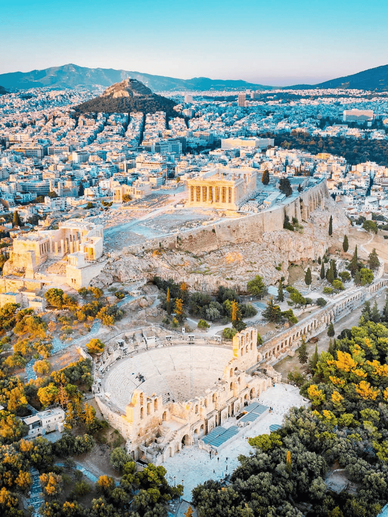 Ancient Greek Theatre of Dionysus in Athens, Greece, with iconic Acropolis in background.