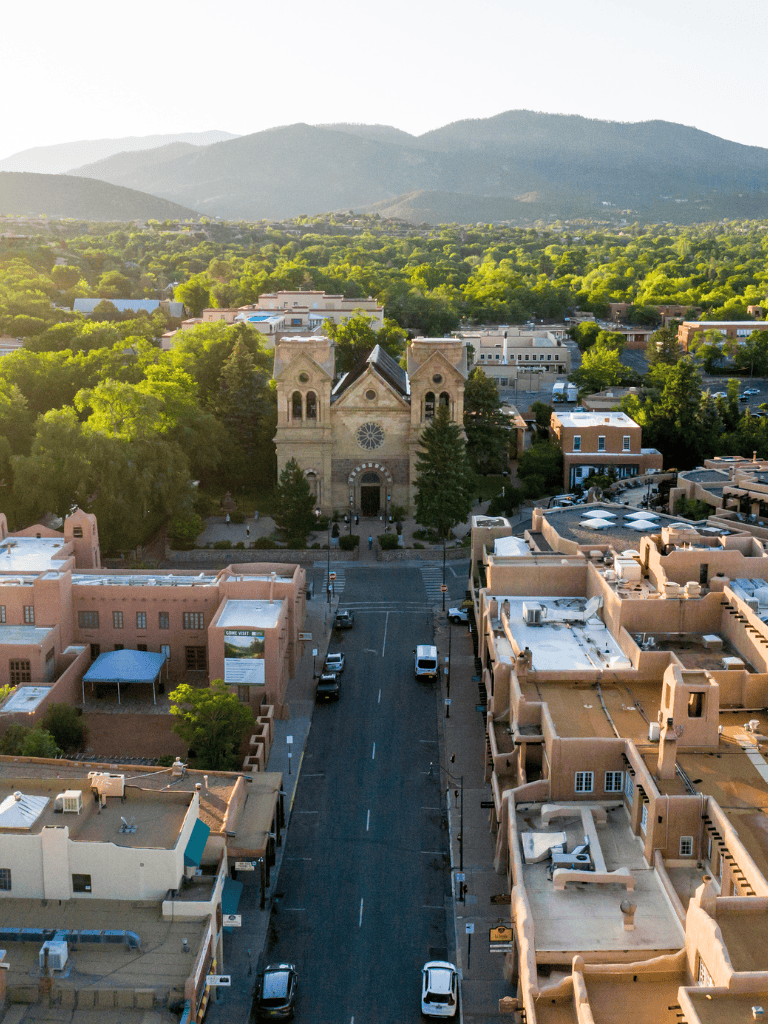 Historic church in downtown Santa Fe, New Mexico, with mountain views and vibrant local architecture.