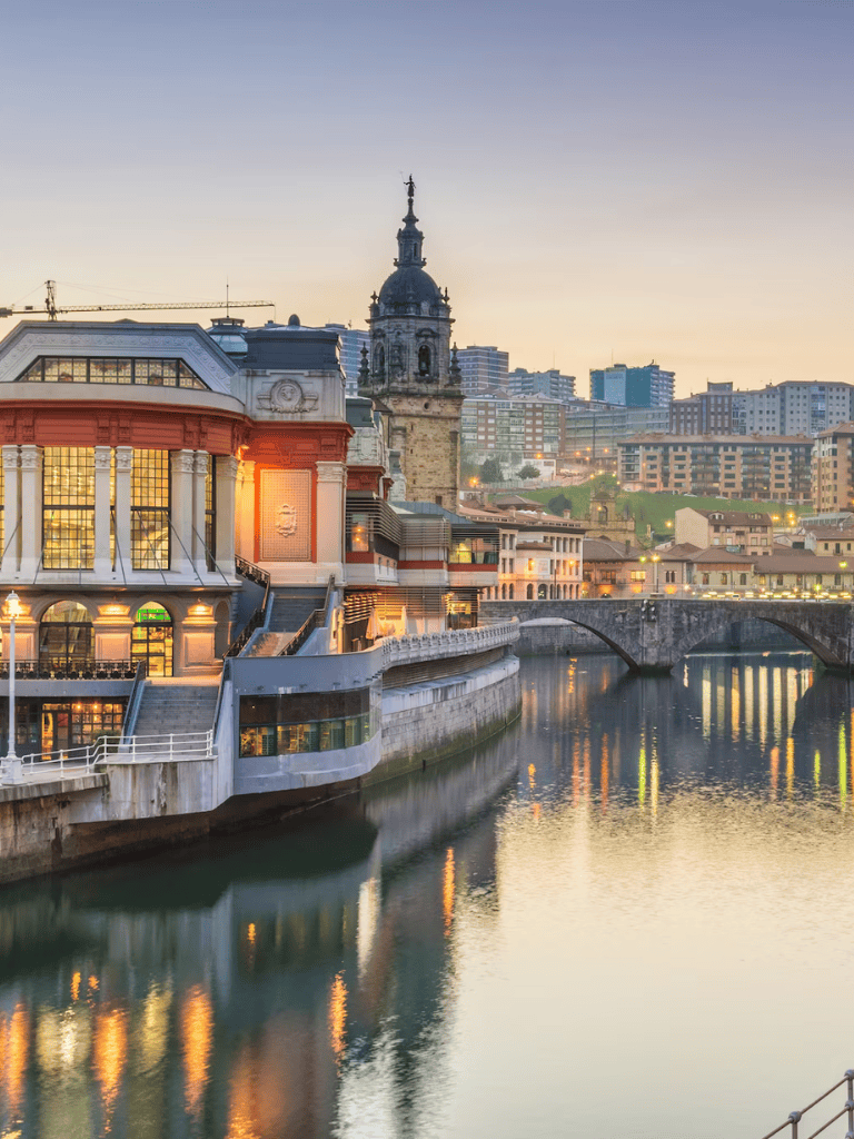 Historic cityscape with river and architecture in the background, vibrant at sunset.