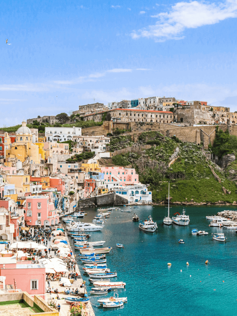 Colorful harbor view of Positano, Italy with boats and hillside villas, ideal for travel planning and destination inspiration.