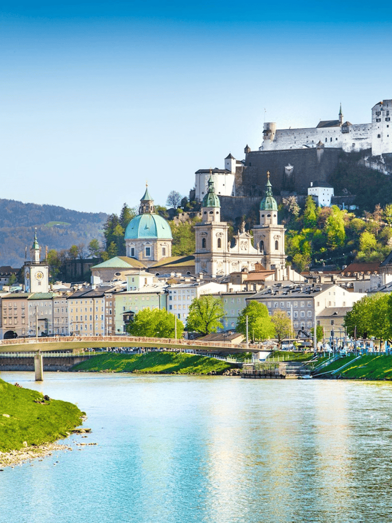 Scenic view of Salzburg, Austria with historic architecture and river, perfect for travel planning and directions.