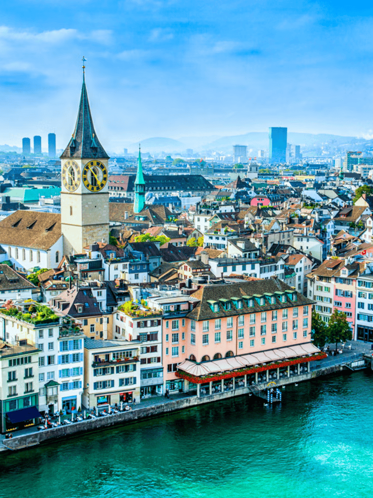 Colorful Zurich cityscape with historic church and lake view, Switzerland travel destination.