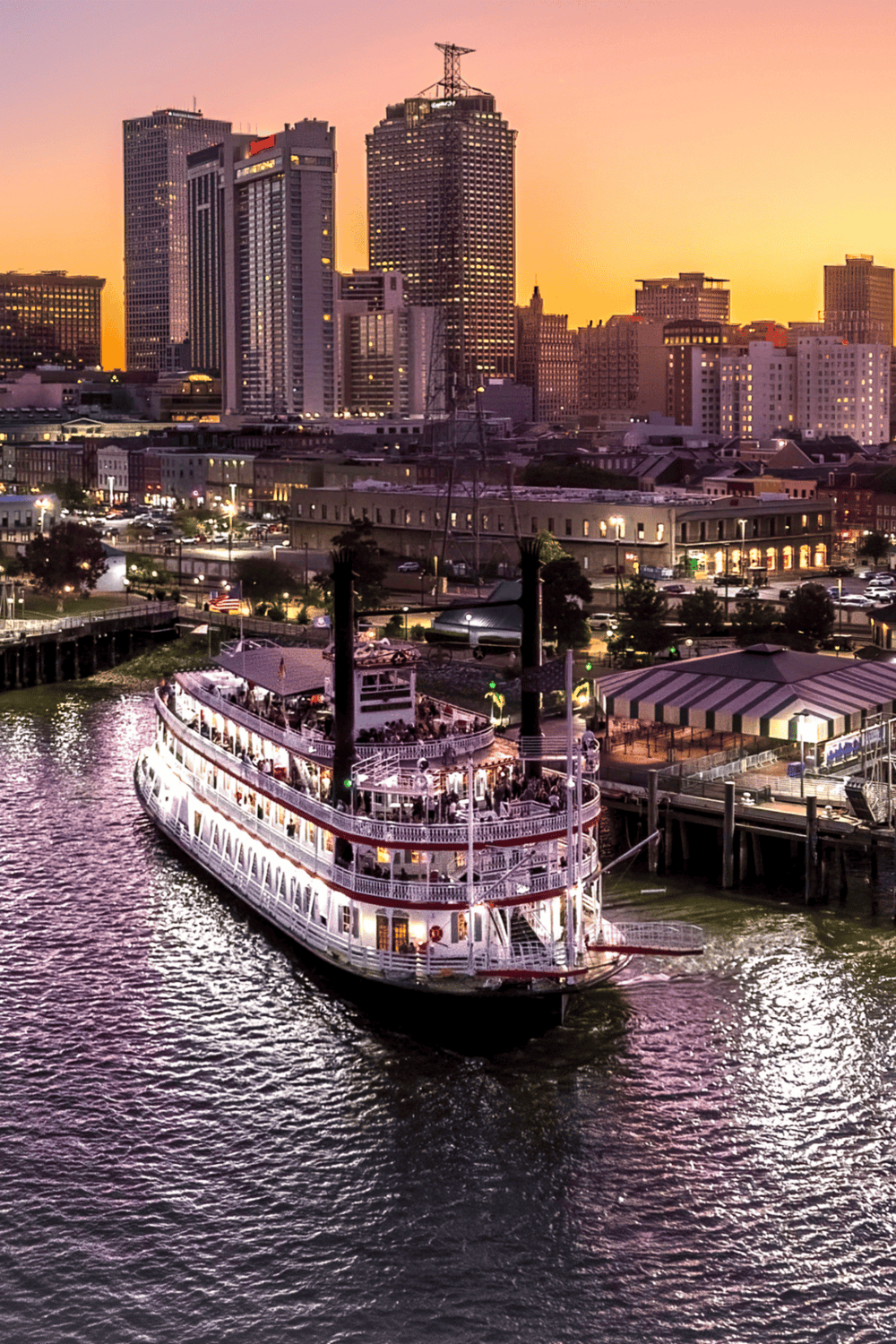 Historic river cruise vessel in downtown city skyline at sunset, skyline, architecture, tourism, cityscape, navigation, QuestForDirections, travel, urban.