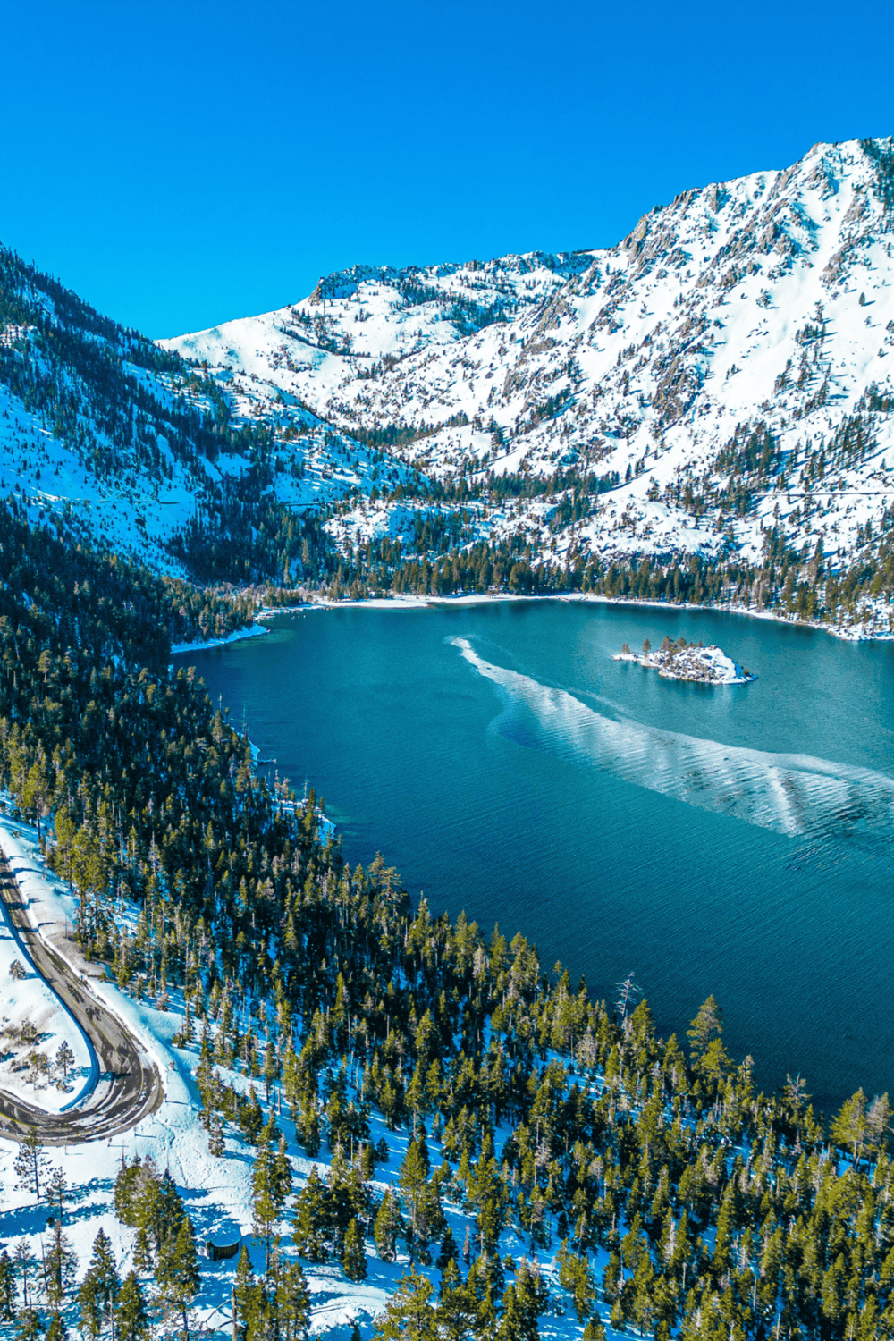 Snow-capped mountains and a serene lake in a winter landscape.