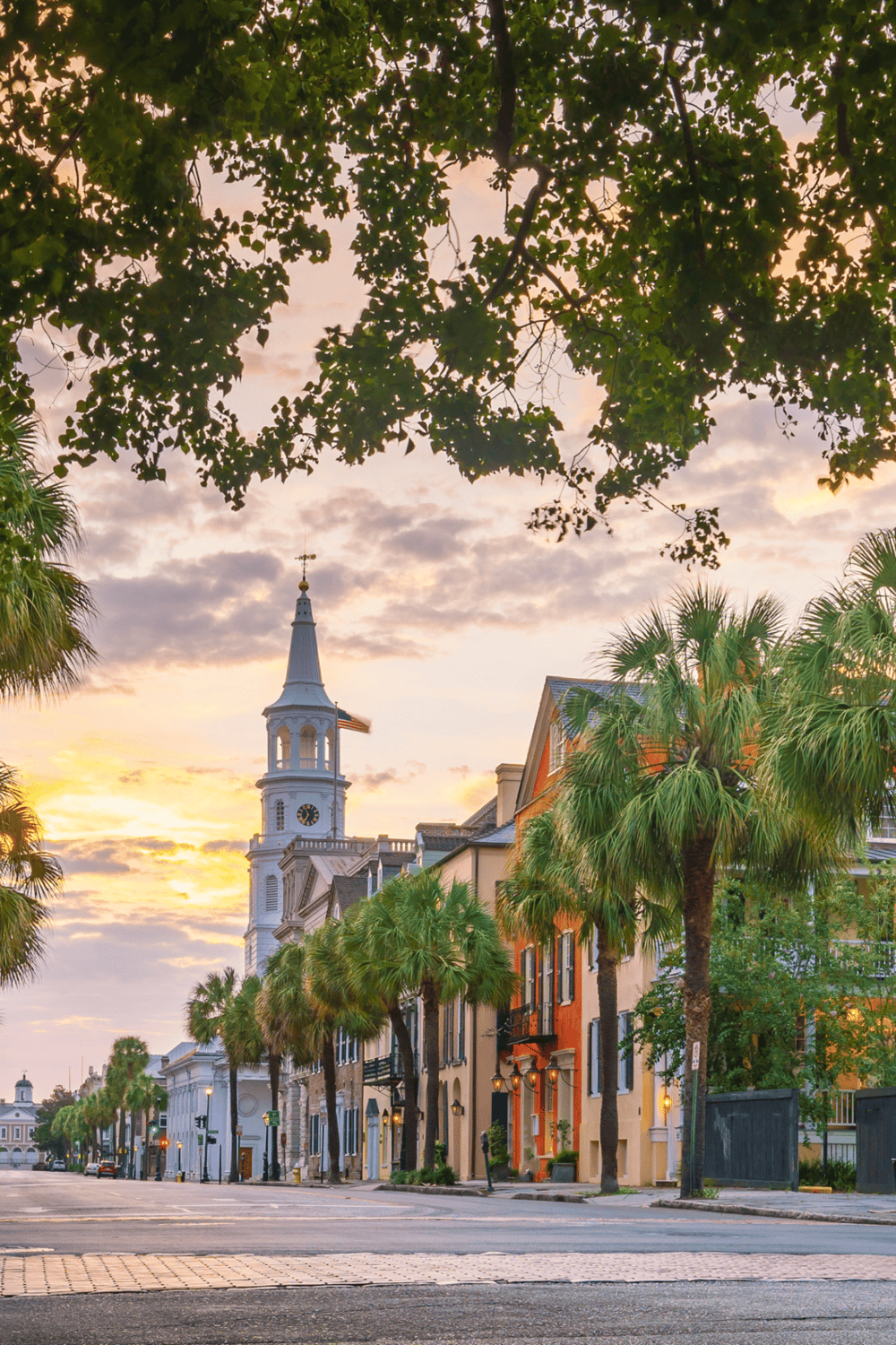 Charming historic street in Charleston with colorful buildings and scenic sunset view.