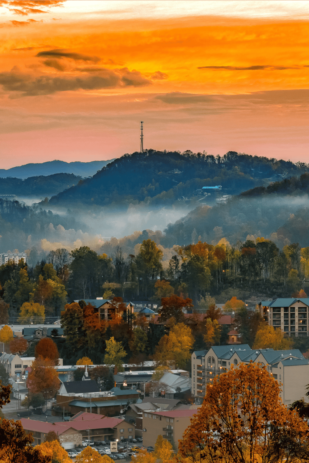 Vibrant mountain town with autumn foliage and scenic sunset views, perfect for travel inspiration.