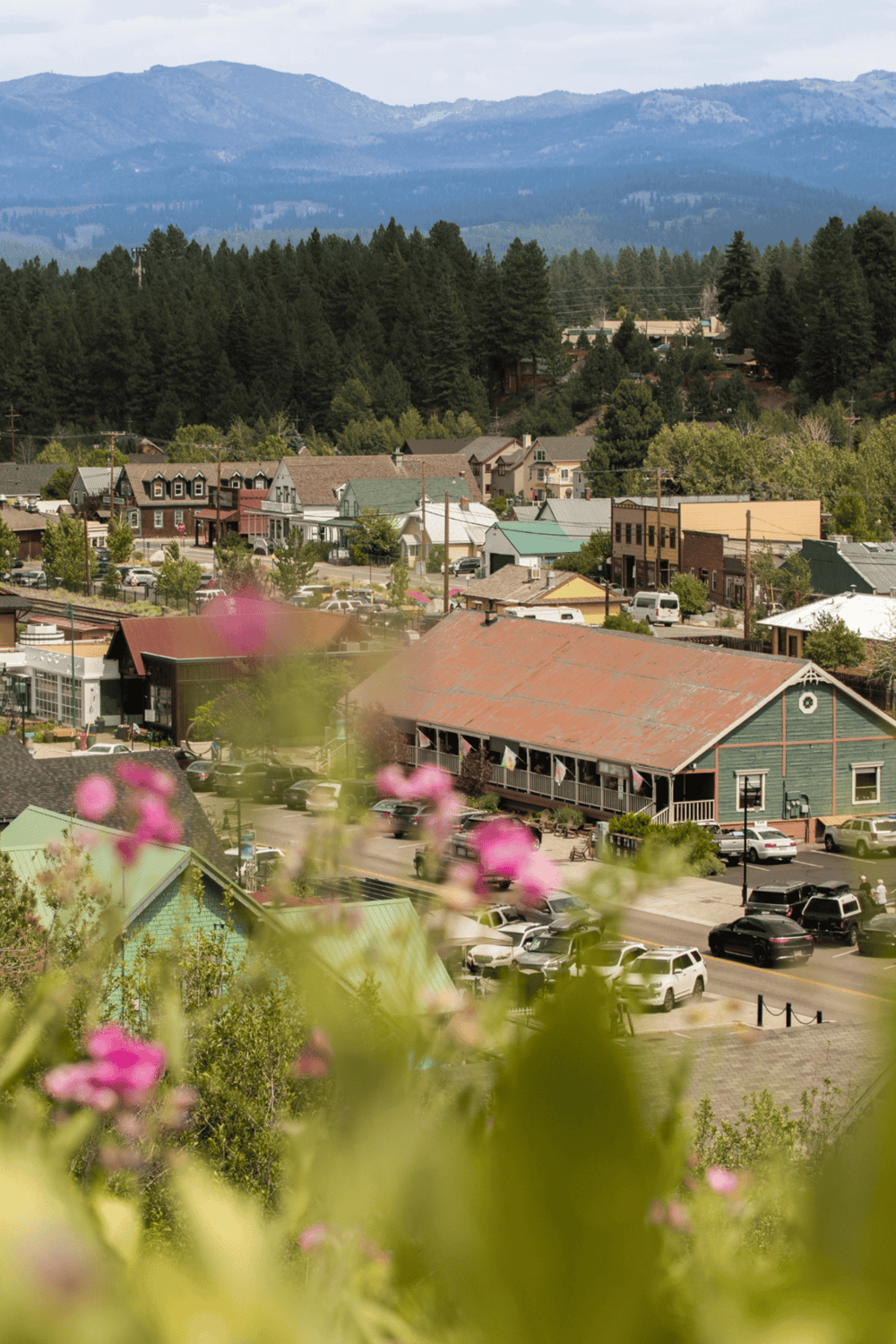 Mountain town streets with colorful buildings and lush greenery, scenic views, and parking areas near QuestForDirections.