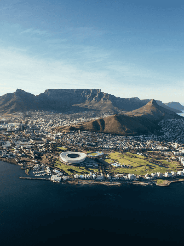 Stunning aerial view of Cape Town with Table Mountain and cityscape, showcasing South Africa's scenic beauty.