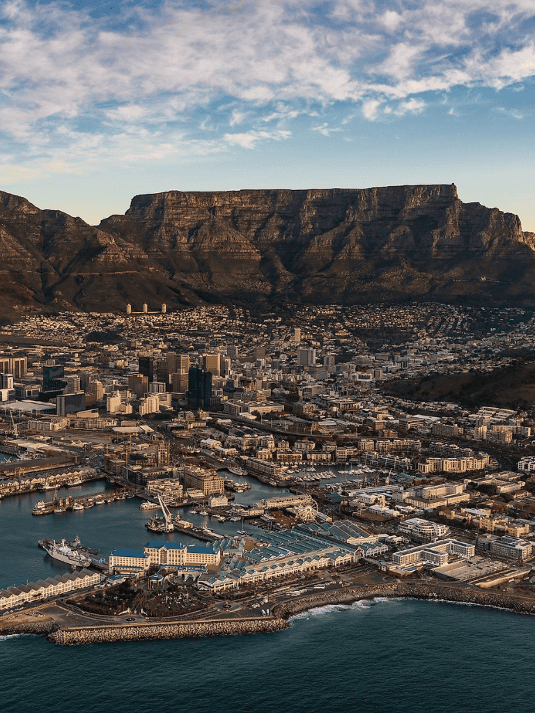 Aerial view of Downtown Cape Town with Table Mountain in the background, showcasing scenic cityscape and harbor.