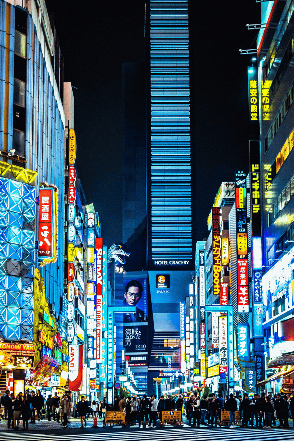 Bright cityscape of Tokyo at night with vibrant neon signs and busy streets, highlighting urban nightlife and entertainment.