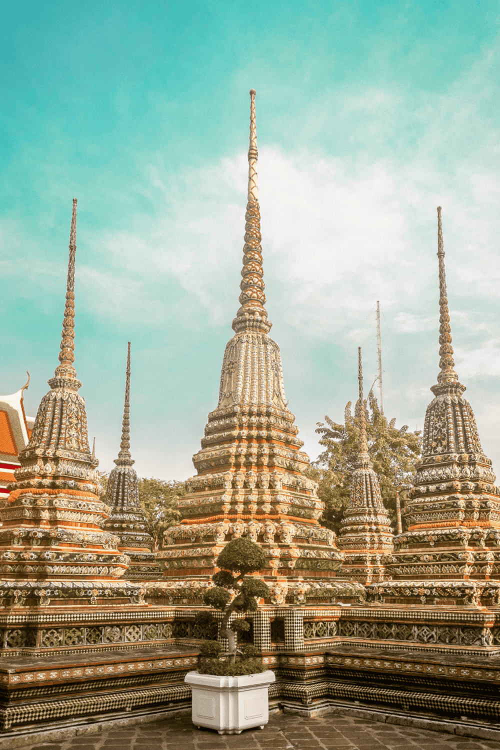 Ornate Thai Buddhist temple stupas with intricate designs, part of QuestForDirections cultural heritage site.