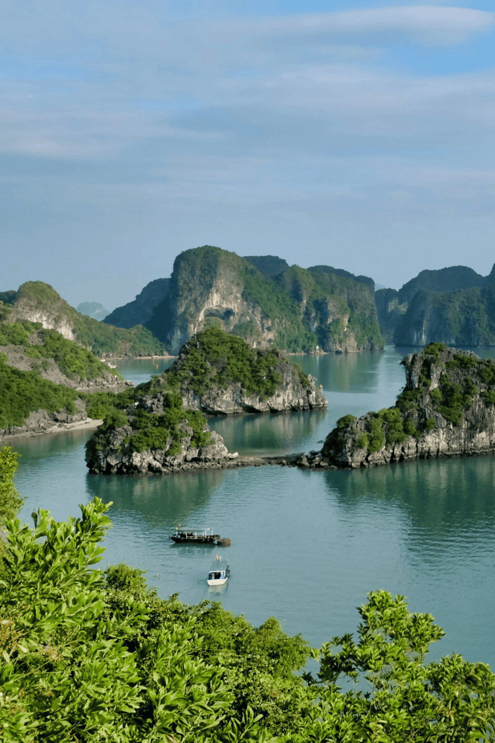 Vast limestone karst islands and emerald waters in a scenic tropical bay.