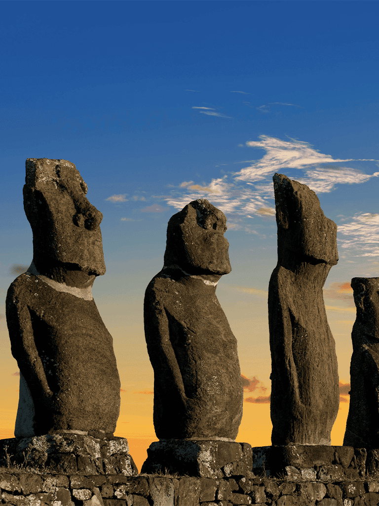 Ancient Moai statues on Easter Island at sunset, iconic landmarks for travel and exploration.