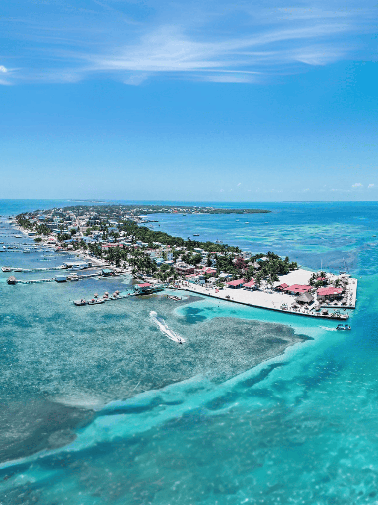 Beautiful Caribbean island with clear blue waters and vibrant coastal town scenery.