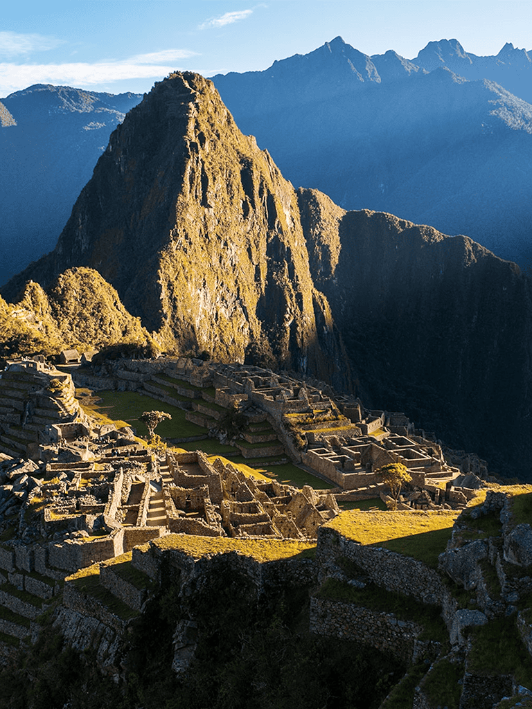 Ancient Inca city Machu Picchu surrounded by towering mountains in Peru.