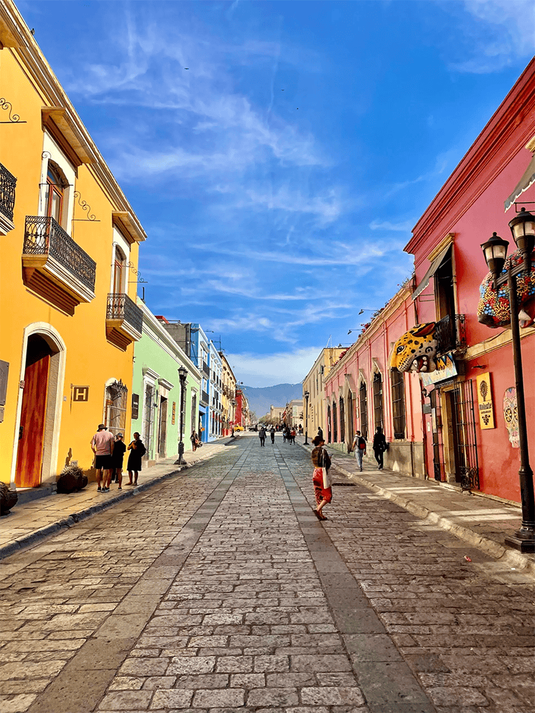 Colorful street in downtown with vibrant buildings and pedestrians, perfect for exploring local culture and history.