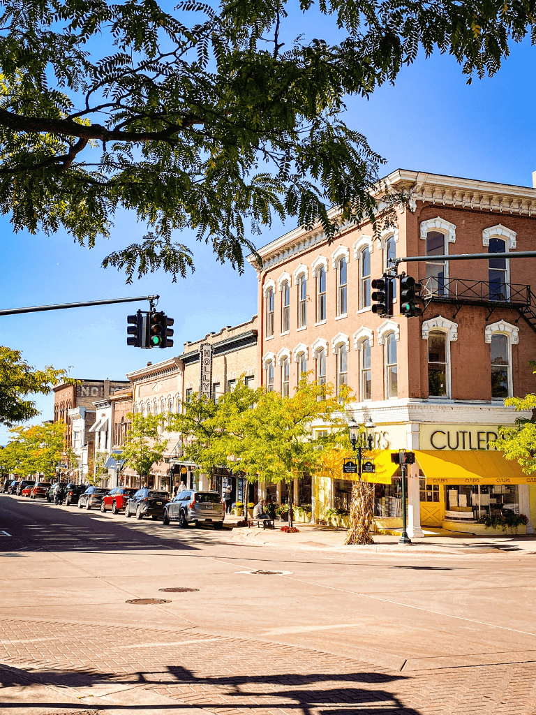 Charming downtown Main Street with historic buildings, shops, and vibrant fall foliage.