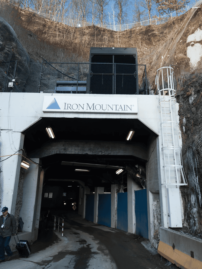 Iron Mountain tunnel entrance at QuestForDirections site, underground storage facility, secure data vault, mountain mountain mining site.