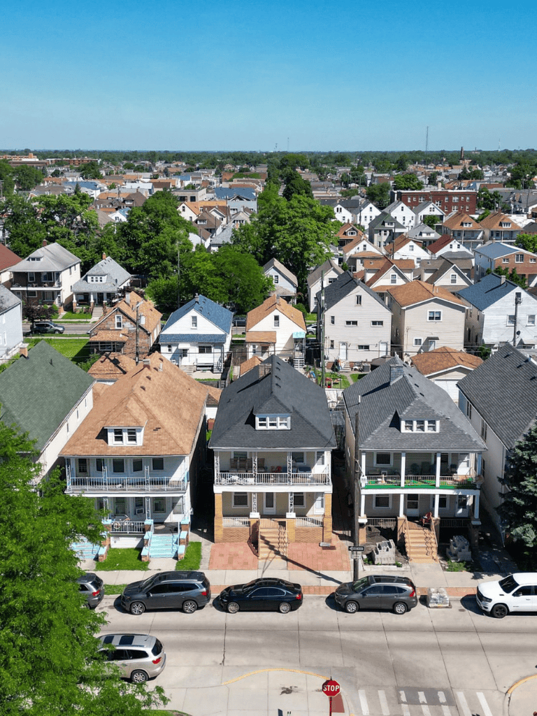 Victorian houses with colorful rooftops on a sunny neighborhood street, perfect for exploring local real estate and homeownership.