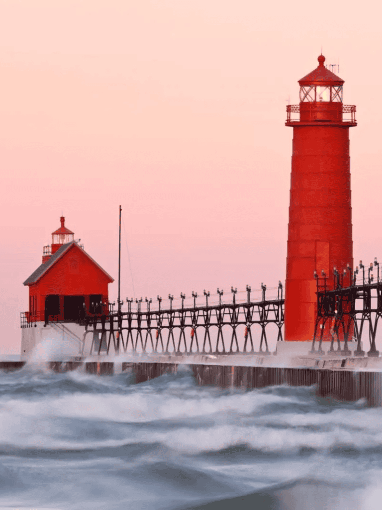 Lighthouse by the ocean during sunset with waves crashing, scenic coastal scenery for travel and navigation.