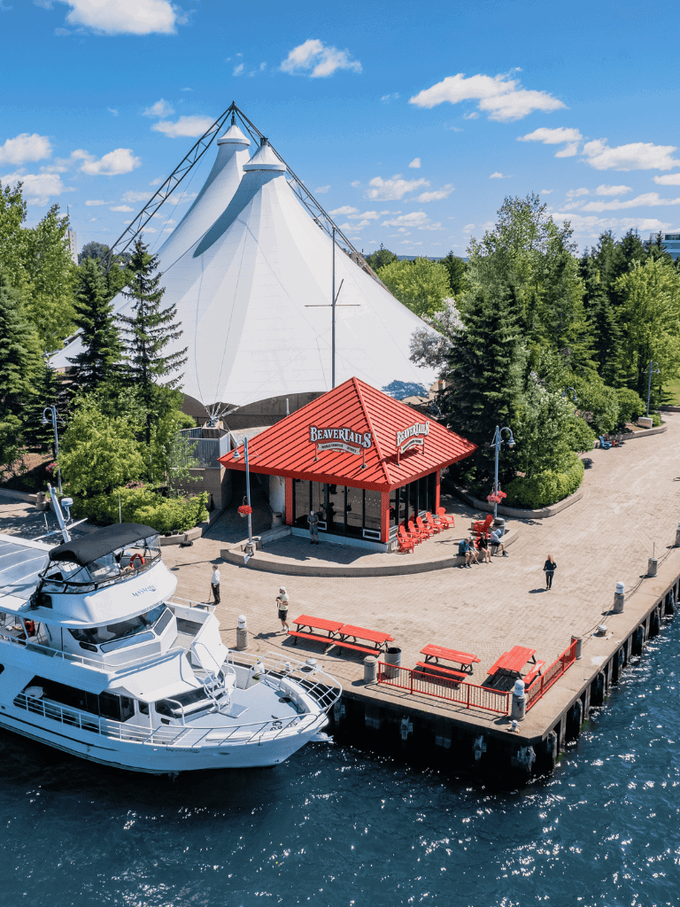 Viking-themed pavilion and dock area at Quest for Directions, surrounded by lush greenery.